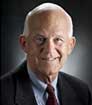 Photo of Dr. Robert Smith smiling and wearing a navy suit and tie